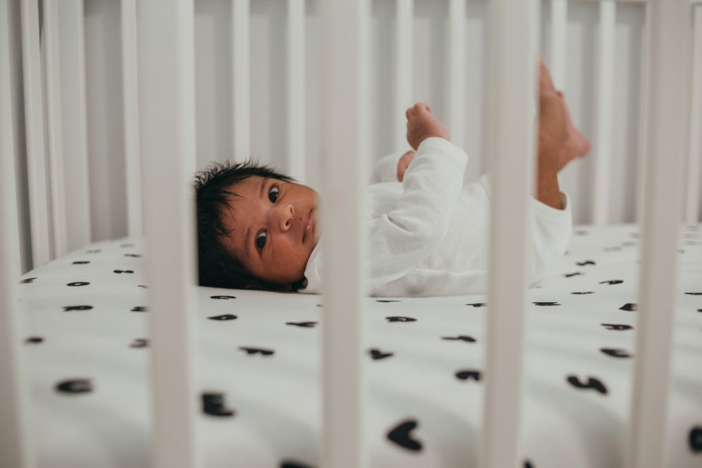 lifestyle newborn photography with baby in his own crib