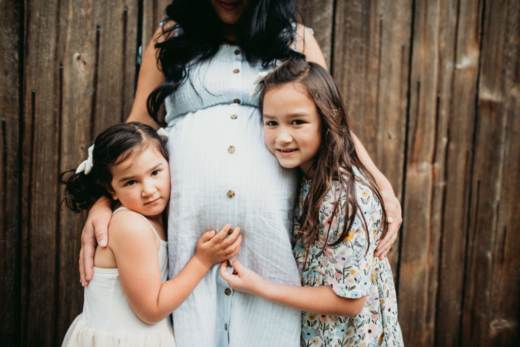 two girls with mom maternity session