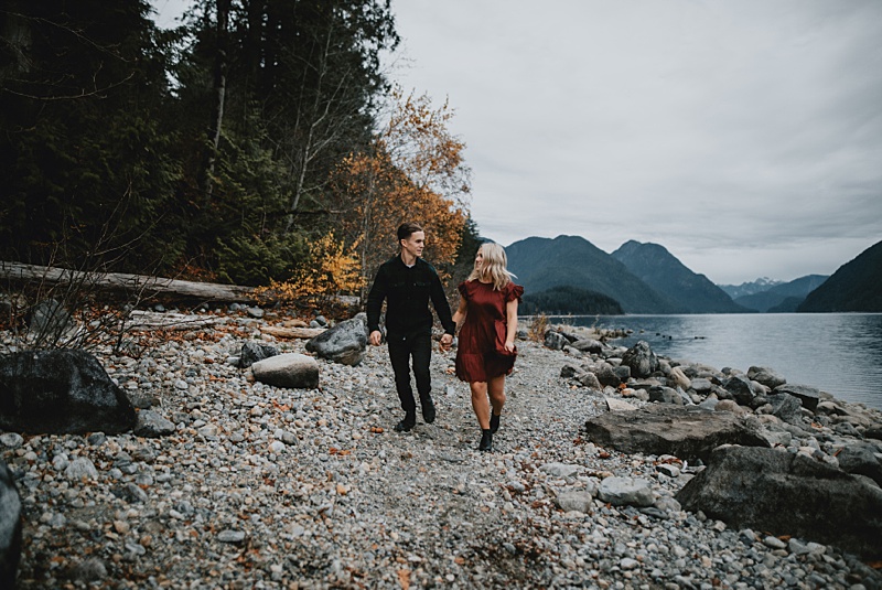 coulpe walking down the beach during their engagement session