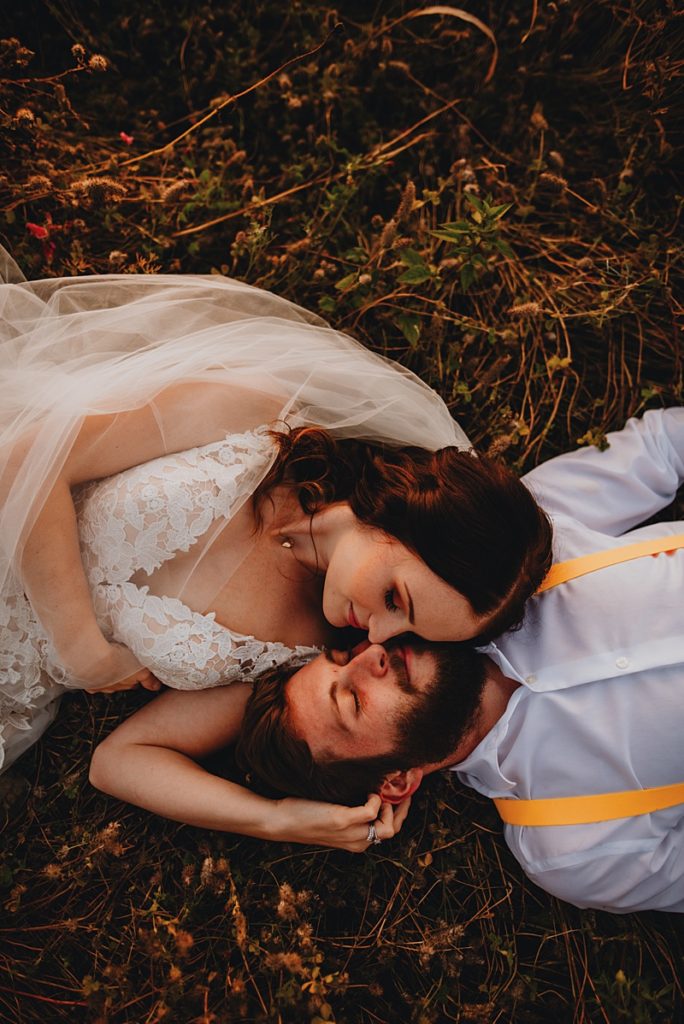 Bride and groom laying in flower field at Cultus lake flower festival, favourite image of 2019 number 4