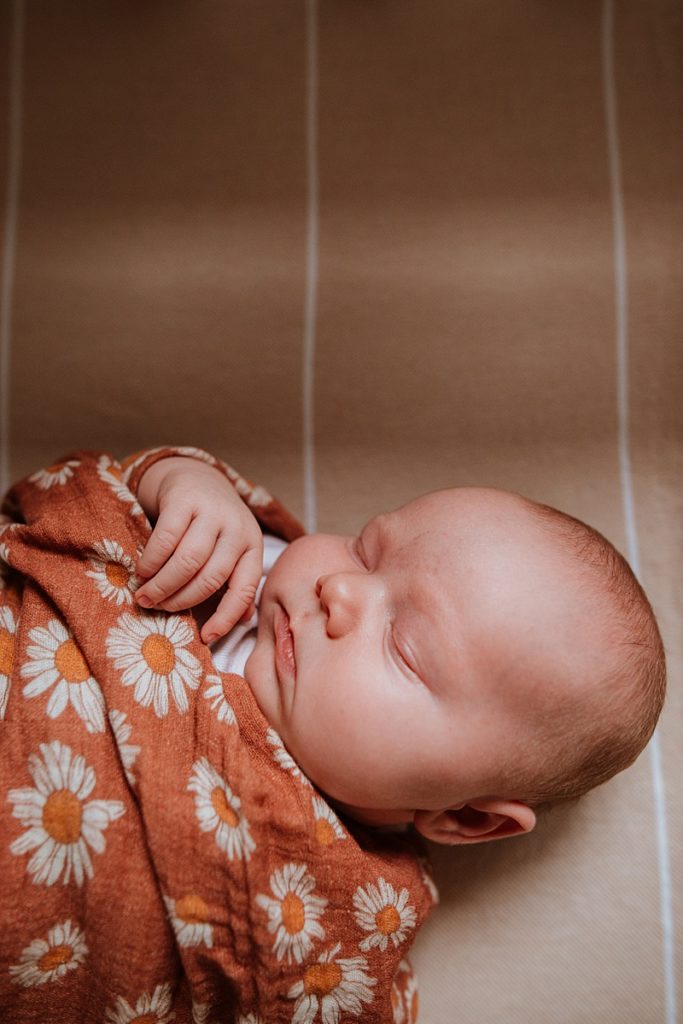 Baby girl in a gorgeous Mini Scout swaddle blanket.
