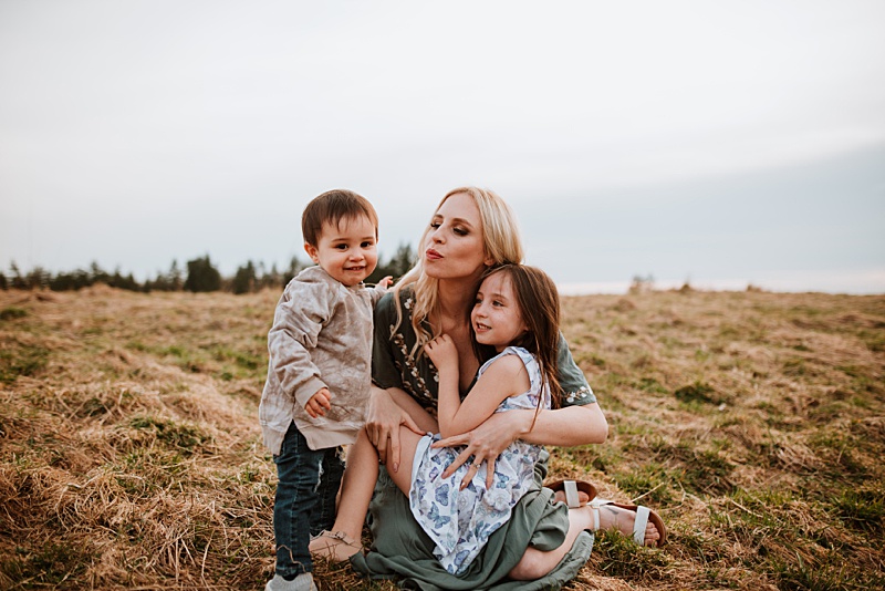 Mom cuddling her kids during a photo shoot with her hair freshly done - hair salons in Vancouver