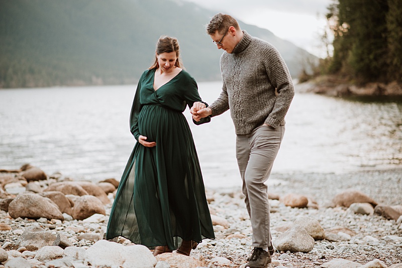 Expectant parents walking on the beach. Obstetricians Vancouver.