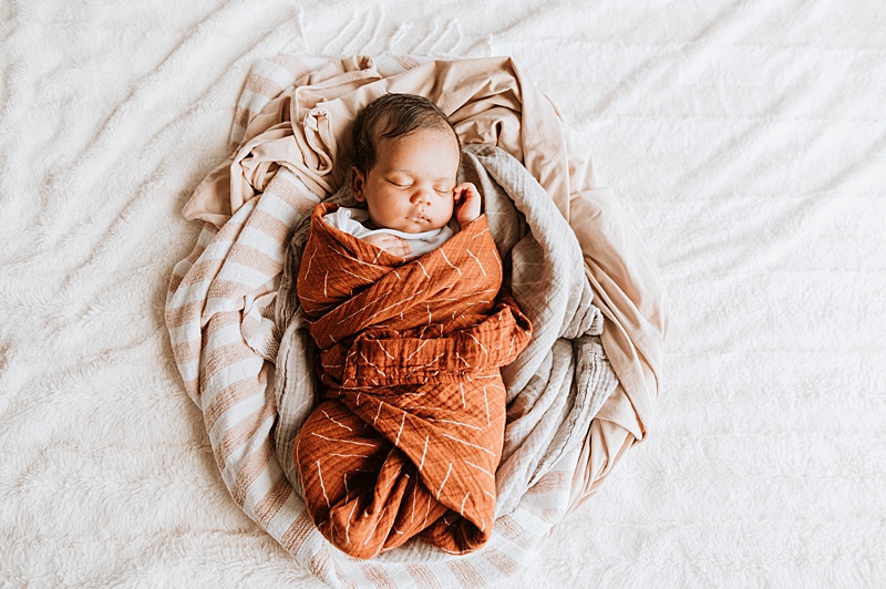 Newborn baby all snuggly. Check out this post for Baby Classes in Vancouver