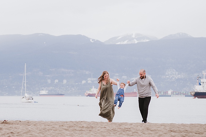 Family of three on a Vancouver beach. Find the best Vancouver Extra-Curricular activities for kids.