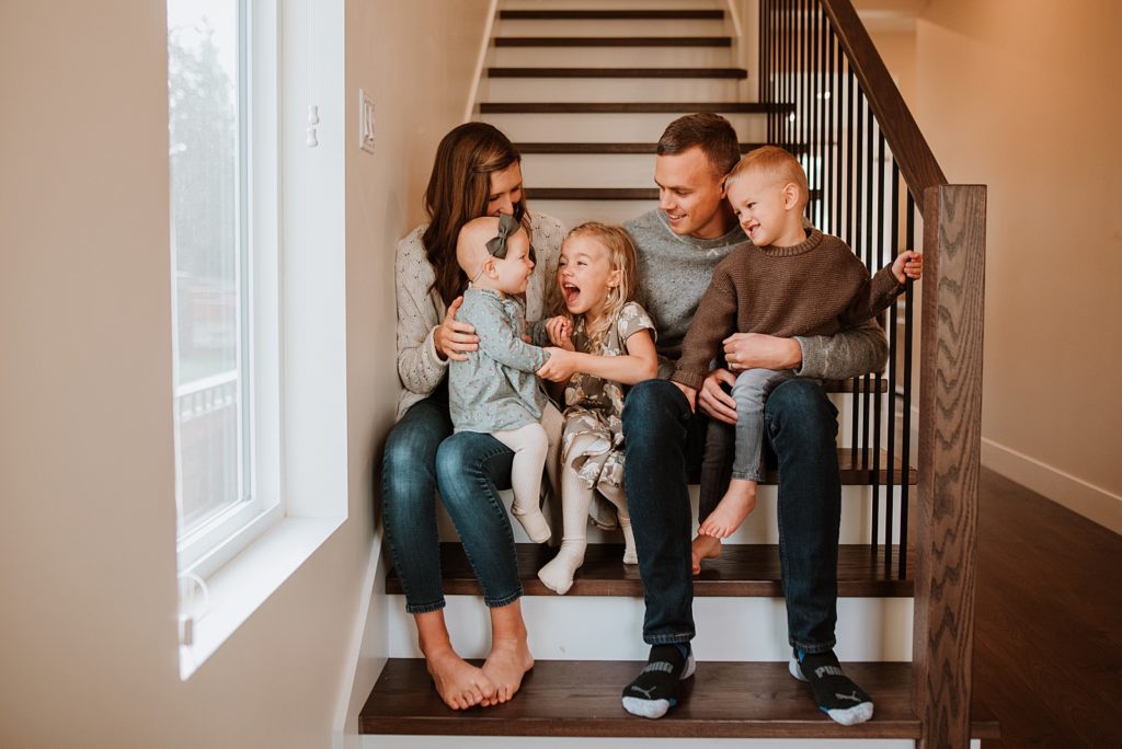 family with kids having a great time by the stairs