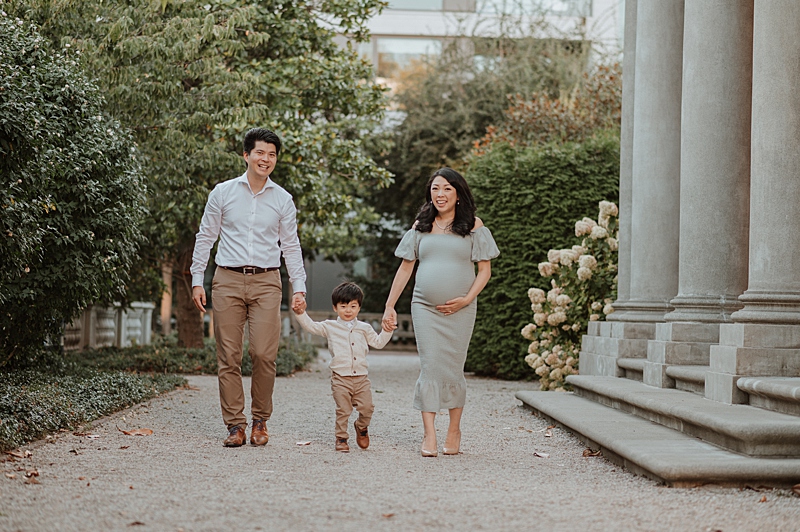 family walking holding hands during a maternity photography session in Vancouver BC