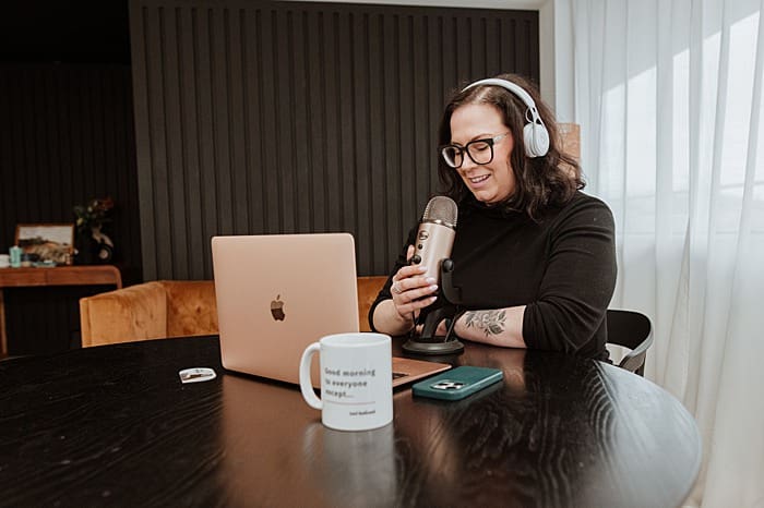 Personal brand photo of Vancouver podcaster recording at a table with microphone and laptop – content photography for creative entrepreneurs