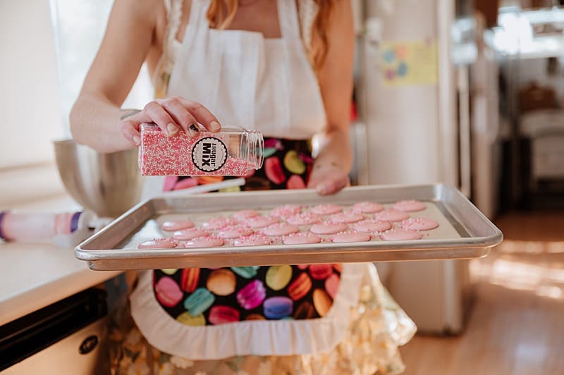 Brand details for baker adding sprinkles to her product during her brand photography session