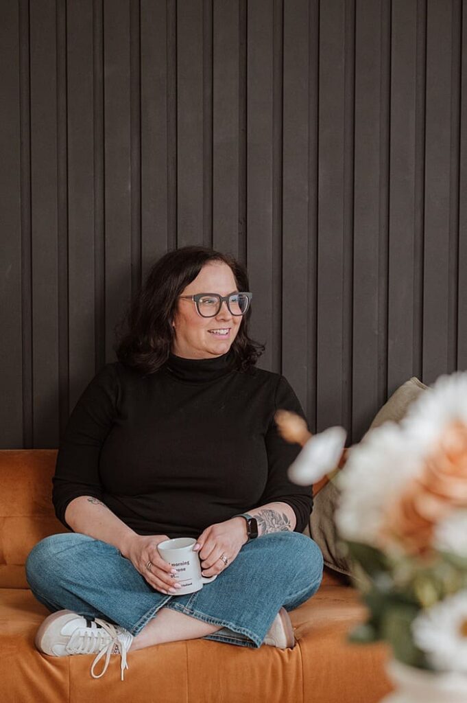 Client smiling during brand shoot with thoughtful workspace details

