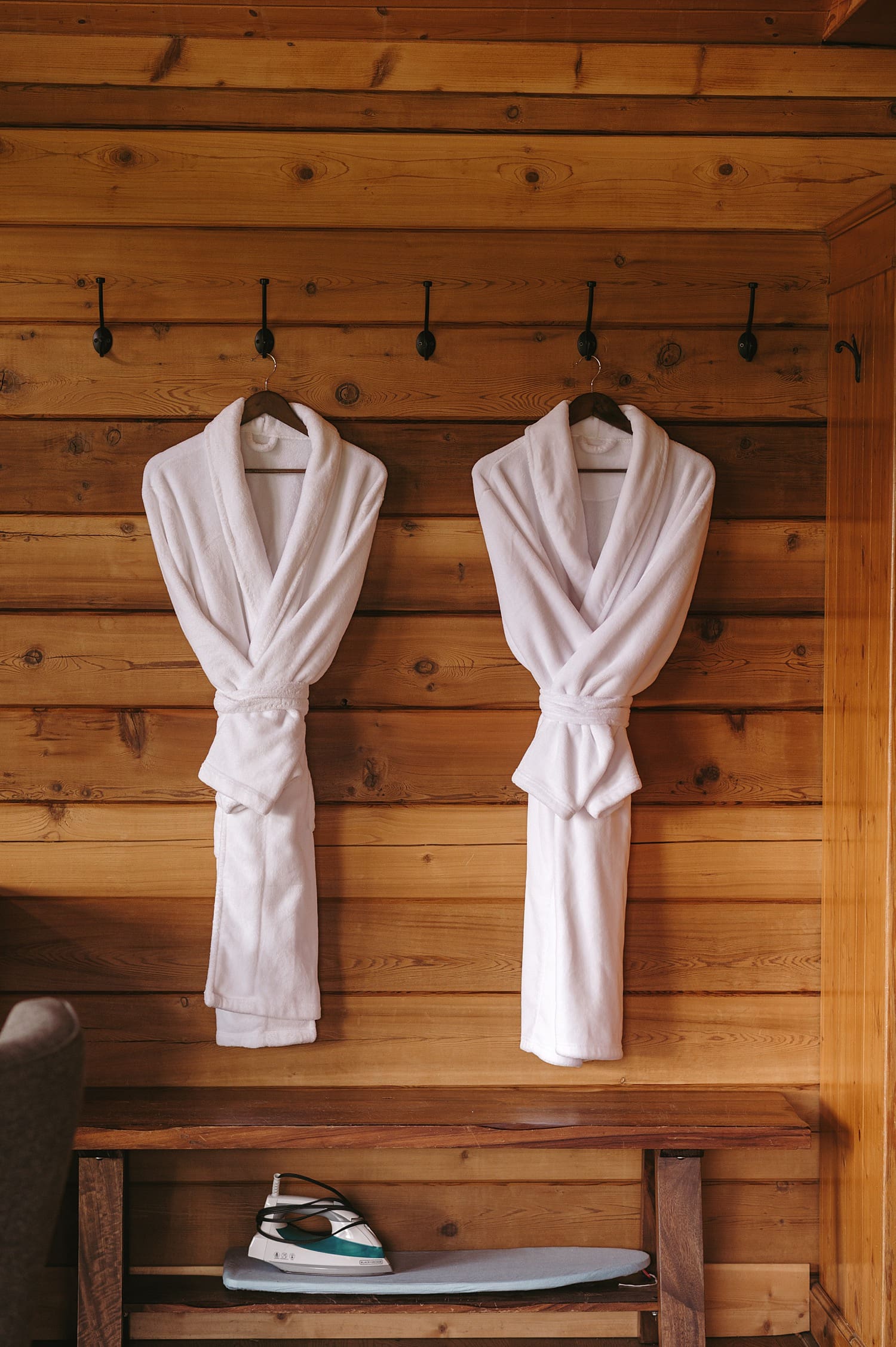 Two luxurious robes hanging in a resort room