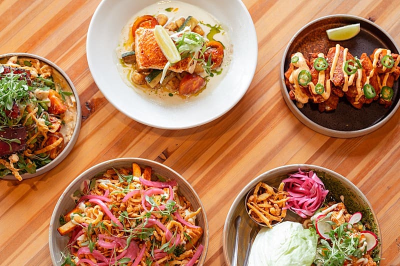 mosaic of beautifully plated dishes on a wood table