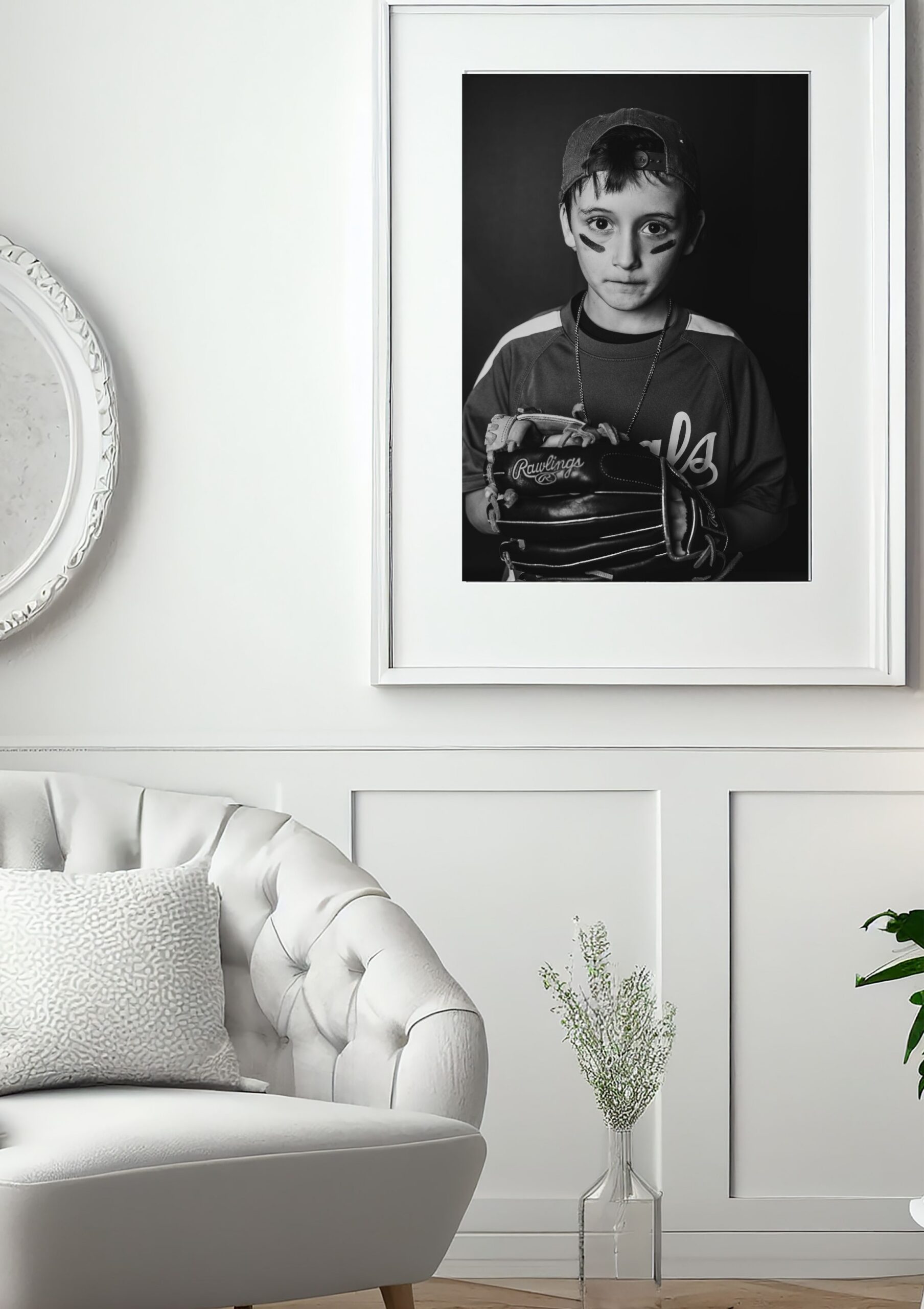 Artwork of a little boy in baseball gear hanging on a wall in a living space.