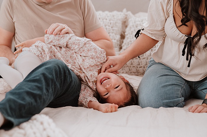 Little girl playing and giggle during a studio family session in Vancouver 